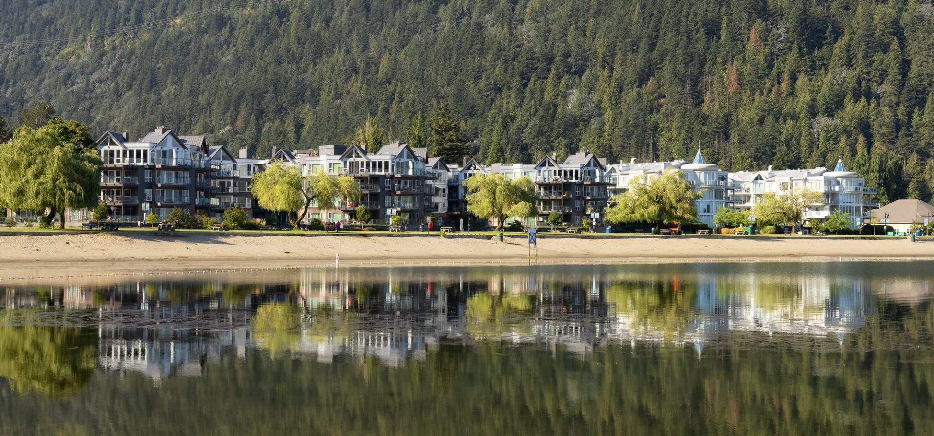 Vacation Homes by the lake and sandy beach. Sunny Summer Morning.